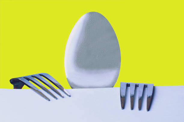 istock A spoon and two forks on a yellow background 1338771999