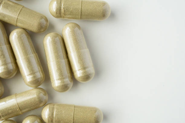 istock Herbal medicine capsules on white background 1338777211