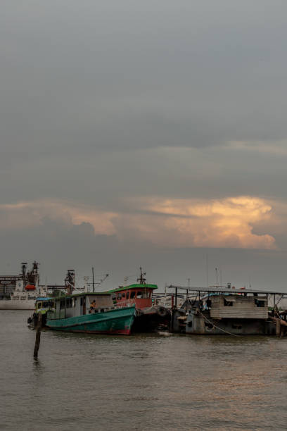 istock Cargo ships in the middle Chao Phraya river near the small pier. 1338777658