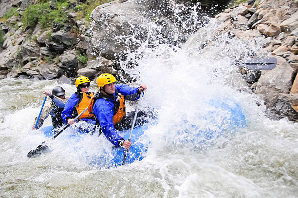 Whitewater Rafting A group of friends whitewater raft on Clear Creek in Colorado rafting stock pictures, royalty-free photos & images