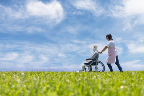 istock Two wheelchairs taking a walk under the blue sky 1338785784