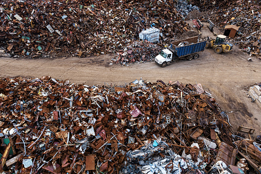 An aerial drone view of a metal scrapyard.
