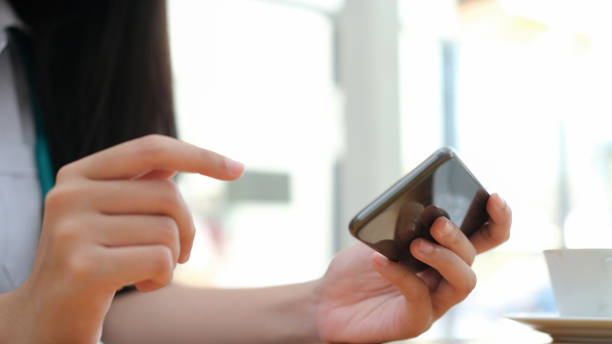 istock Close up of woman using mobile phone. 1338797864