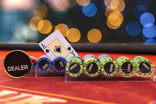 judge's gavel stands next to playing cards poker chips on green table. responsibility for the underground casino. illegal gambling. isolated