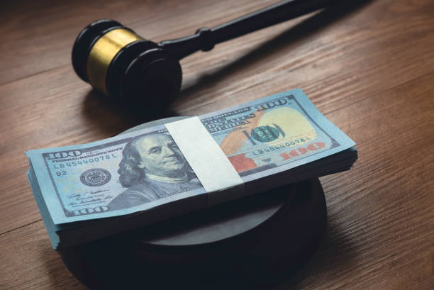 istock Selective focus of money on a gavel base. 1338800312