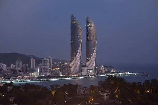 Iconic Xiamen Shimao twin towers at night viewed from Gulangyu island, Fujian, China
