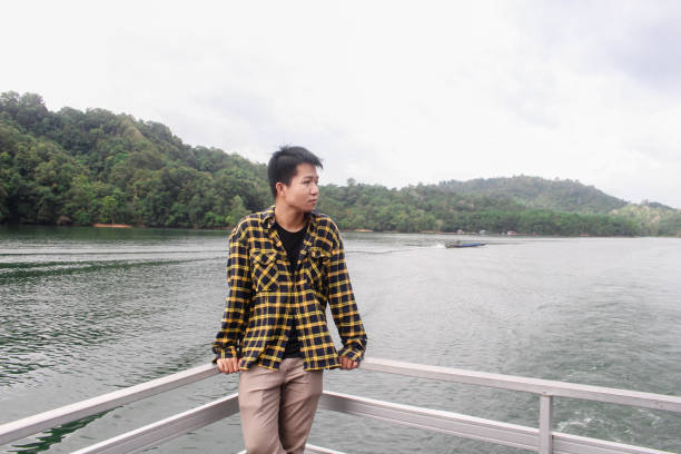 istock young man relaxing by the lake 1338803141