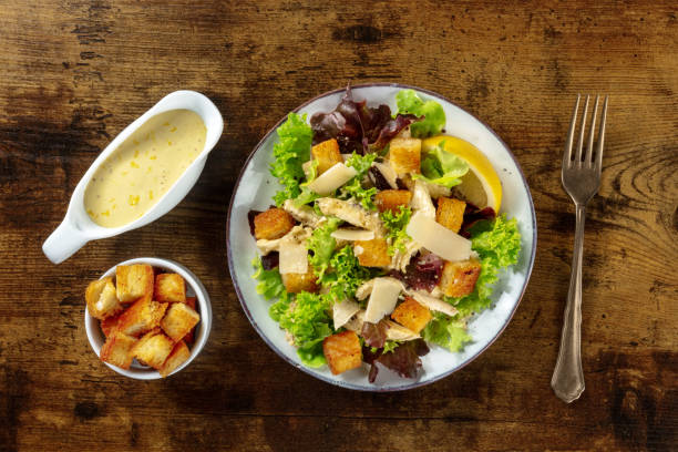 istock Chicken Caesar salad, overhead flat lay shot with the classic sauce 1338803231