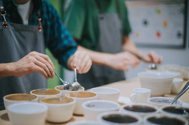 istock midsection Asian Chinese barista scooping coffee ground cleaning for coffee cupping tasting  scope 1338803492