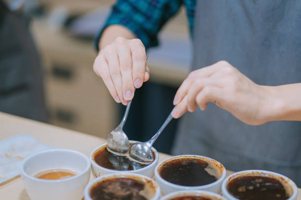 istock midsection Asian Chinese barista scooping coffee ground cleaning for coffee cupping tasting  scope 1338803494
