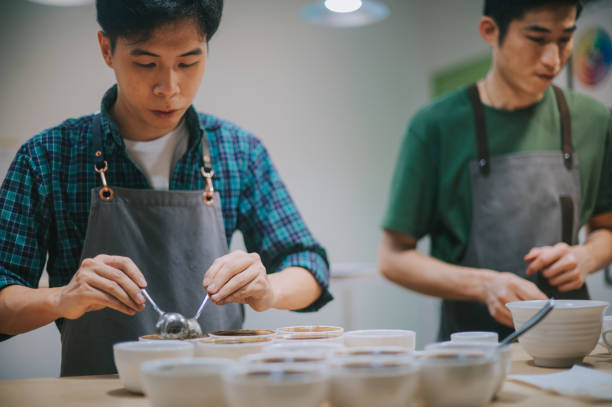 istock Asian Chinese barista scooping coffee ground cleaning for coffee cupping tasting  scope 1338803505