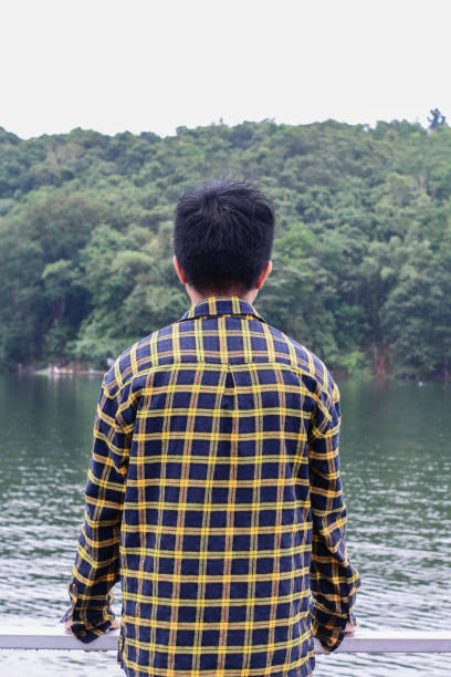 istock young man relaxing by the lake 1338804207