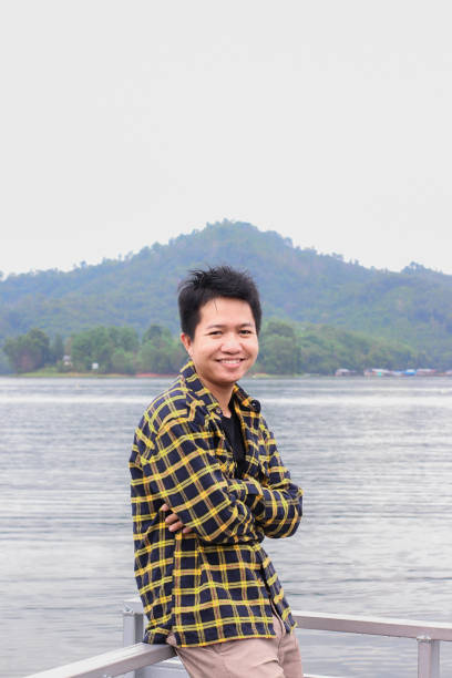 istock young man relaxing by the lake 1338804244