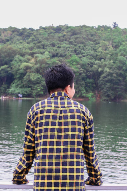 istock young man relaxing by the lake 1338804267
