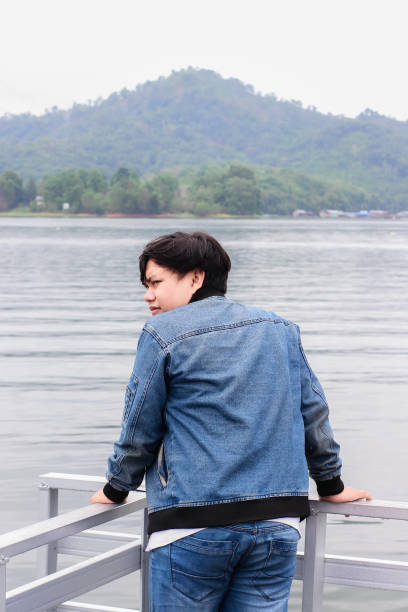 istock young man relaxing by the lake 1338804335