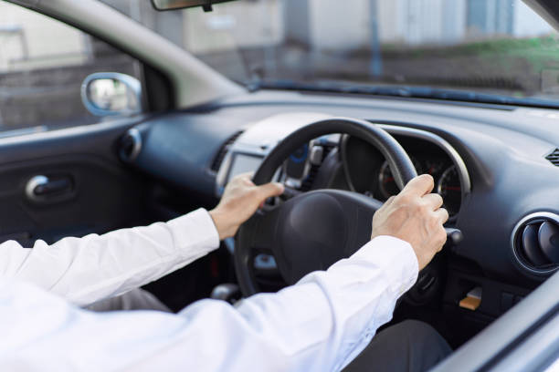 Hands of a man driving a car