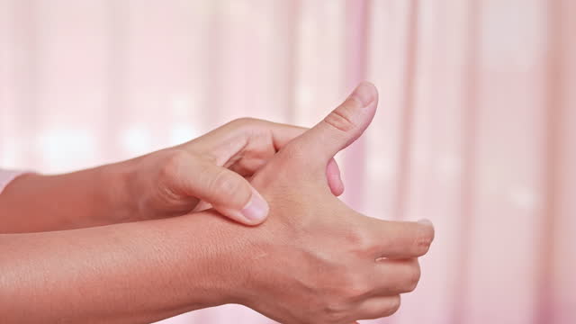 Closeup of female massaging her painful hand and numbness caused by prolonged work on the computer or housewife, Carpal tunnel syndrome, arthritis. Neurological disease concept.