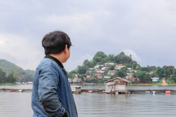 istock young man relaxing by the lake 1338805428