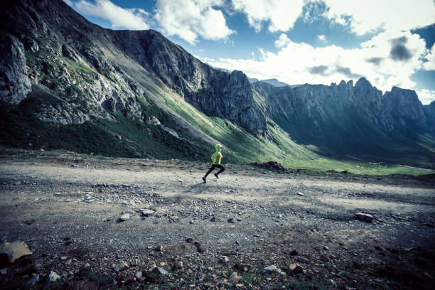 istock Woman trail runner running on mountain top 1338806156