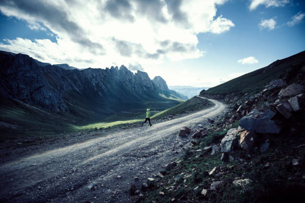 istock Woman trail runner running on mountain top 1338806163