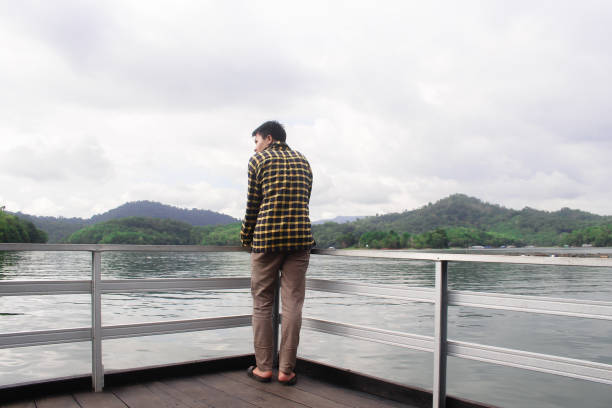 istock young man relaxing by the lake 1338806209