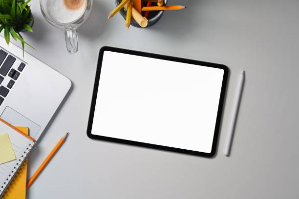 istock Top view digital tablet, stylus pen, laptop computer and stationery on white office desk. 1338807013
