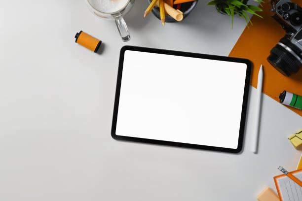istock Top view photographer workplace with digital tablet, camera and coffee cup. 1338807036