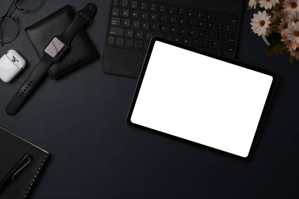 istock Above view digital tablet, smart watch and wallet on black leather. 1338807044