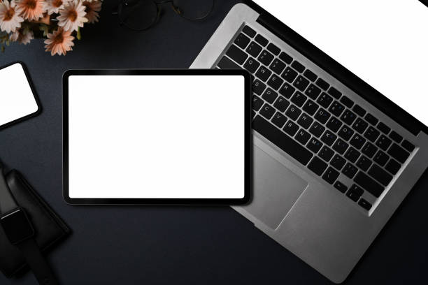 istock Above view dark modern workspace with digital tablet, laptop computer and smart phone on black leather. 1338807048