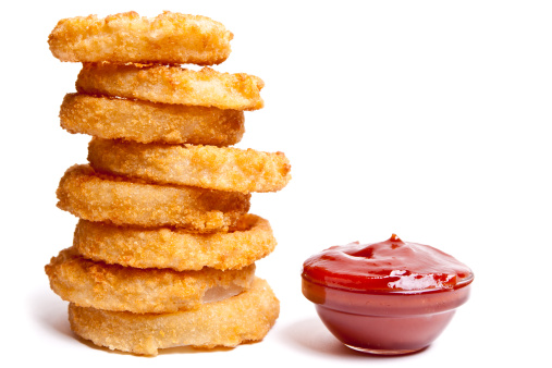Stack of onion rings with ketchup.  Isolated on white.