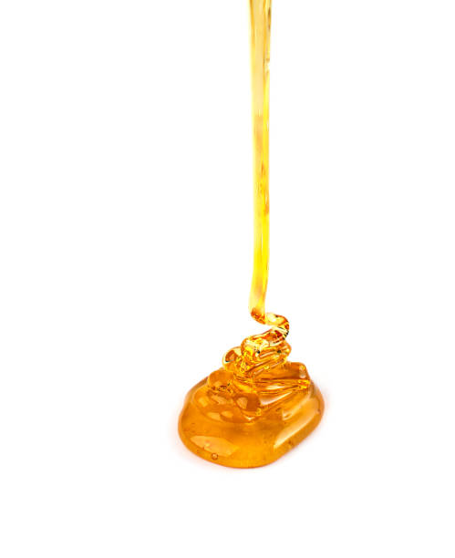 istock Pouring honey isolated on white background. 1338809922