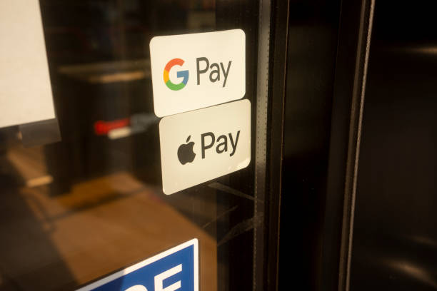 Google Pay and Apple Pay Tigard, OR, USA - Sep 3, 2021: Google Pay and Apple Pay stickers are seen at the entrance to a shop in Tigard, Oregon. apple computer stock pictures, royalty-free photos & images