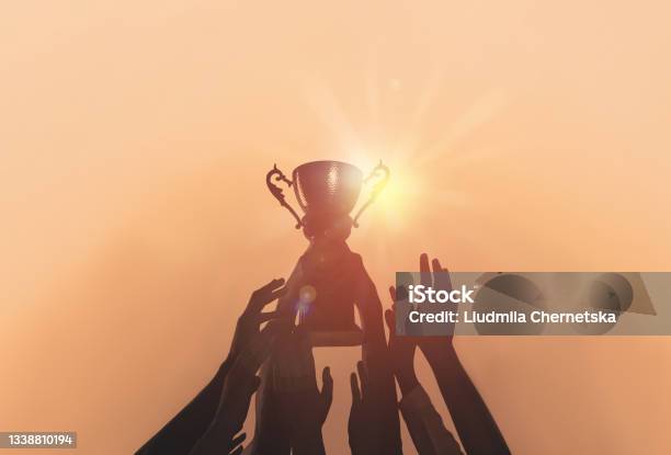 People With Gold Trophy Cup On Color Background Closeup Stock Photo - Download Image Now