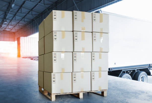 istock Shipping Cargo Container. Truck Parked Loading at Dock Warehouse. Delivery. Warehouse Logistics. Cargo Freight Truck Transportation. 1338810359