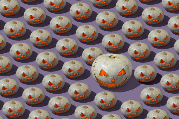 istock Pattern of Grey and orange Jack o' Lantern on violet background. Halloween pumpkin with lights and shadow 1338810475