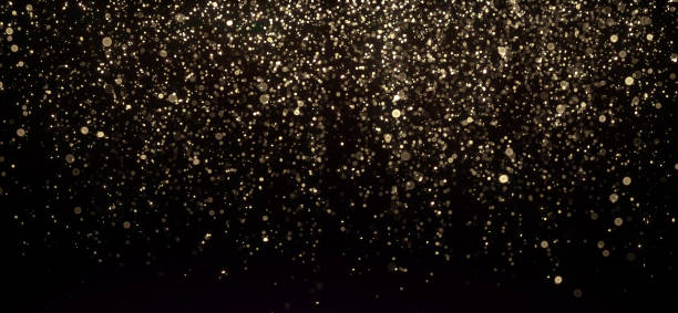 istock Gold glitter texture on black. Shinny small particles reflecting light. 1338812299