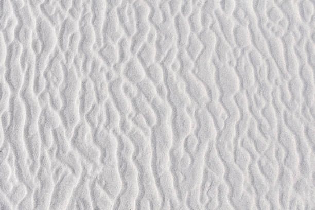 istock Various shapes in white sand. Abstract irregular texture on beach. Summer background. 1338812586