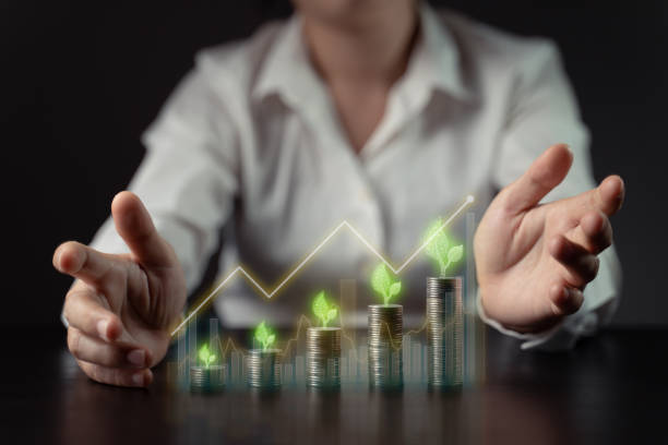 istock Businessman with coin stack and hologram chart. 1338814743
