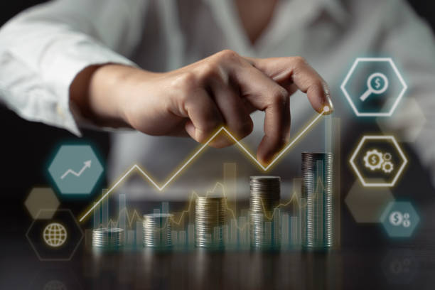 istock Businessman with coin stack and hologram chart. 1338814763