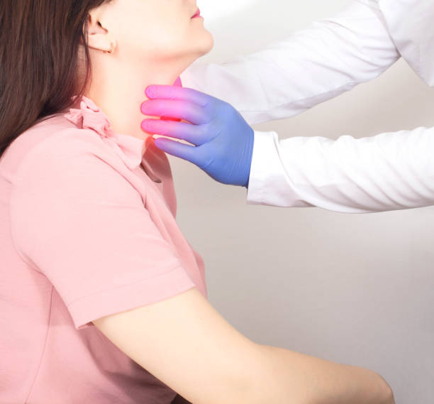 A neurologist doctor checks the throat of a girl who has a lump in her throat, dryness and soreness. Neurological Emotional Disorder Concept A neurologist doctor checks the throat of a girl who has a lump in her throat, dryness and soreness. Neurological Emotional Disorder Concept, symptomatology oesophagus stock pictures, royalty-free photos & images