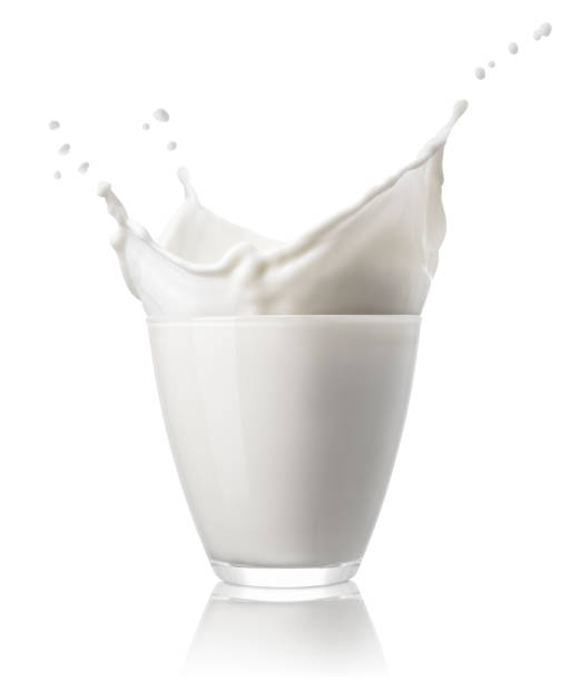 glass with splashing milk isolated on white stock photo
