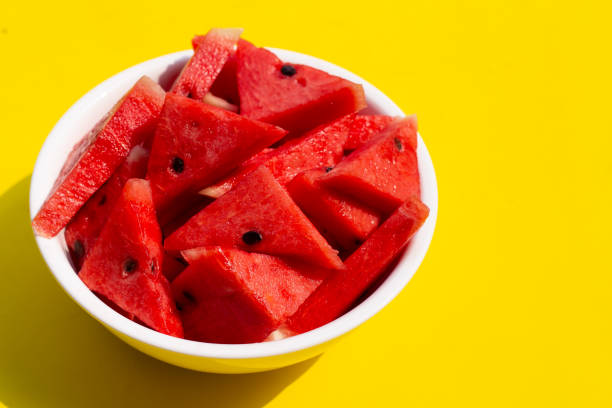 istock Watermelon in white bowl on yellow background. 1338818844