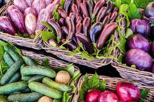 A detailed view of some varieties of fresh and healthy eggplants, cucumbers and Tropea onions. The traditional Mediterranean diet consists of natural, healthy and fresh products, including fruits, vegetables and grains. Image in high definition format.