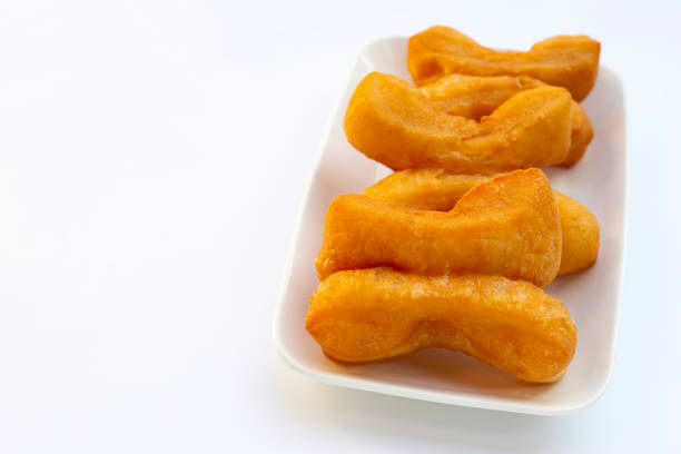 Deep-fried dough sticks or chinese bread sticks on white background.
