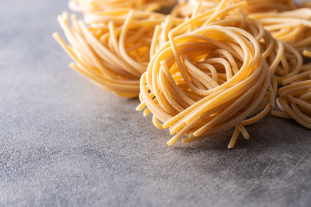 istock Italian pasta nest. Uncooked spaghetti nest. 1338821948