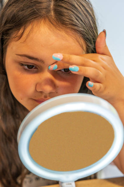 istock Thirteen year old girl close up having eyebrows plucked 1338822201