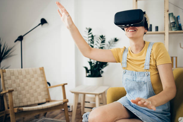 istock Portrait of a young woman using a virtual reality headset and having fun 1338822210