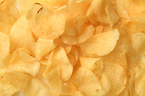 Overhead shot of Crispy Potato Chips texture background.