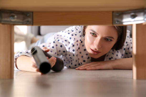 istock Young woman using vacuum cleaner at home 1338822395
