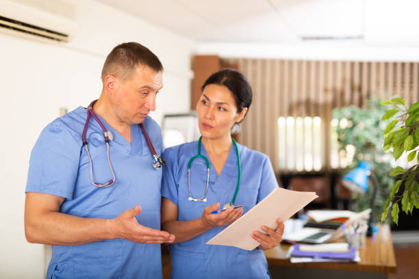 istock Two doctors checking patient papers in clinic 1338827193